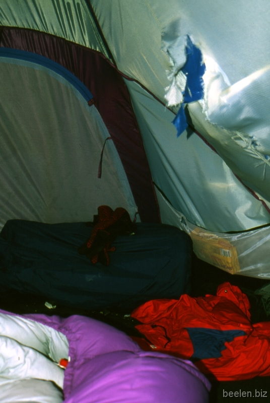 176_Camp 1 Stone-hole Very soon K2 proved a dangerous place.
With the melting snow big stones fell!
Especially in the afternoon many many stones came down.
The fast-approaching, agressive humming sound of the falling and bouncing rocks was very frightening.
I once had to sleep inside this tent, right under the rock-hole.
I considered sleeping with my helmet on.