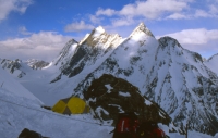 167_Camp 1 Anglo View at Windy Gap (China border) from camp 1.
We were the first to enter here; we had the best places. 
The yellow tent is from the Anglo-American expedition. It balances on a very small ridge.
The ropes are for securing the tents in case of stormy circumstances.